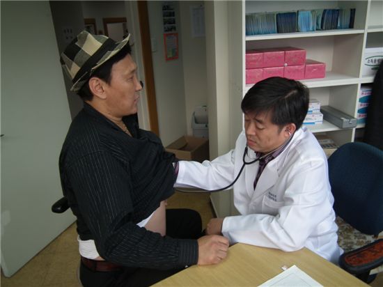 봉사에 나선 의사가 외국인환자를 진찰하고 있다.