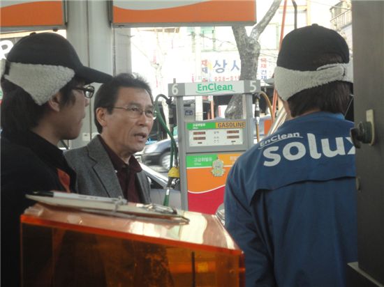 23일 오후 서울 성북구 보문동의 한 주유소에서 기름을 넣던 고객이 "기름값이 너무 비싸다"며 직원들에게 볼멘소리를 하고 있다.