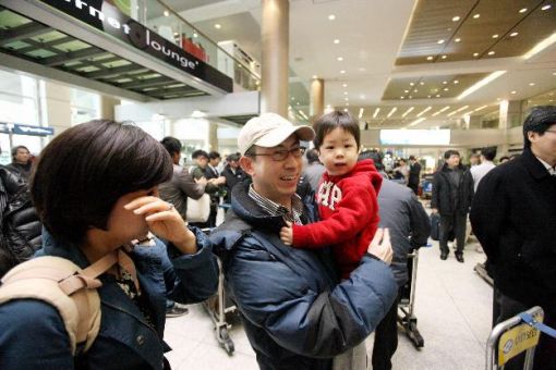 리비아 현장에서 철수해 인천공항에 도착한 대우건설 직원이 마중 나온 가족과 만나 기뻐하고 있다.