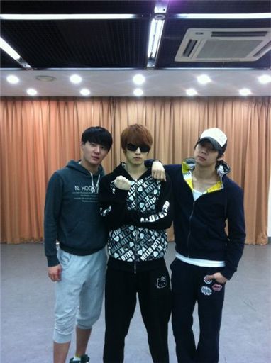 JYJ members pose in track suits 