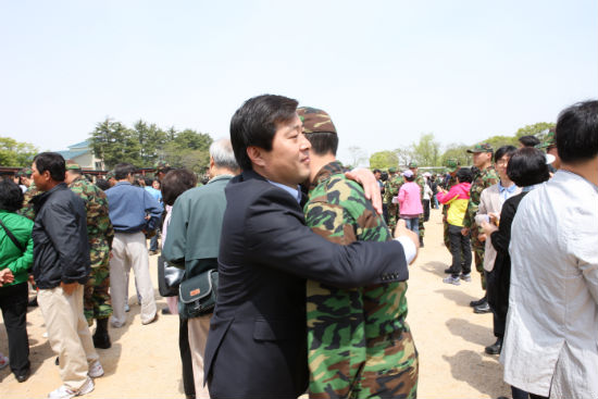 이등병 계급장을 달아준 뒤 아들을 안아주는 아버지.(사진제공=논산시)