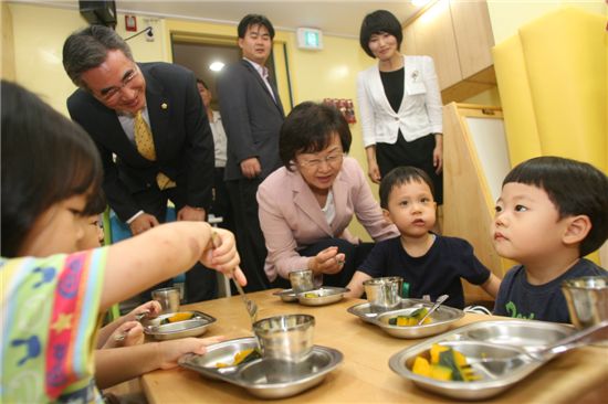 신연희 강남구청장이 어린아이들에게 간식을 먹여주고 있다.