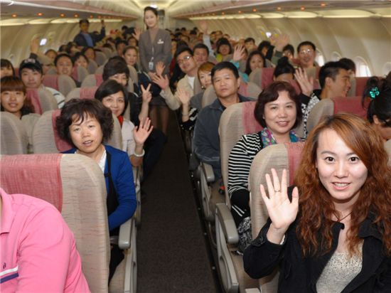 지난해 10월부터 아시아나항공이 운영하는 국내 최초 중국인 관광객 전용기인 '제주쾌선(濟州快線)'에 탑승한 중국인 승객들이 기념촬영을 하고 있다.