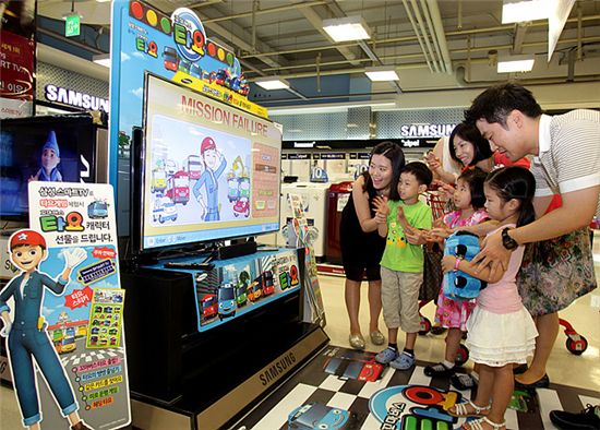 서울 금천홈플러스 내 삼성전자 매장에서 어린이들이 부모와 함께 삼성스마트TV의 '타요' 앱을 이용하고 있는 모습.