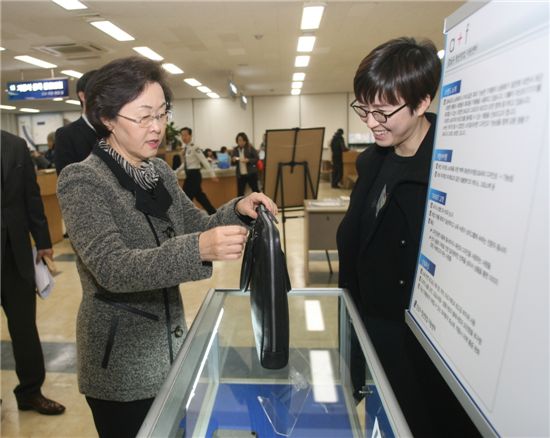 신연희 강남구청장이 청년창업센터 졸업기업 전시회에서 제품을 살펴보고 있다.
