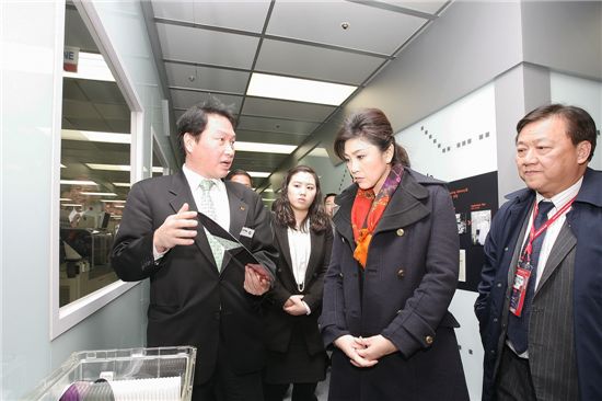 최태원 회장이 25일 SK하이닉스 이천공장을 방문한 잉락 총리에게 웨이퍼를 들고 반도체 사업에 대해 설명하고 있다.