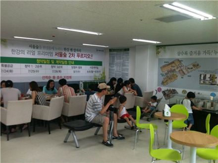 ▲'서울숲 2차 푸르지오' 단지 내 상가에 마련된 분양사무소. 오는 25~26일 청약을 앞두고 가족들과 함께 분양 상담을 받기 위해 찾아온 사람들로 붐빈다.