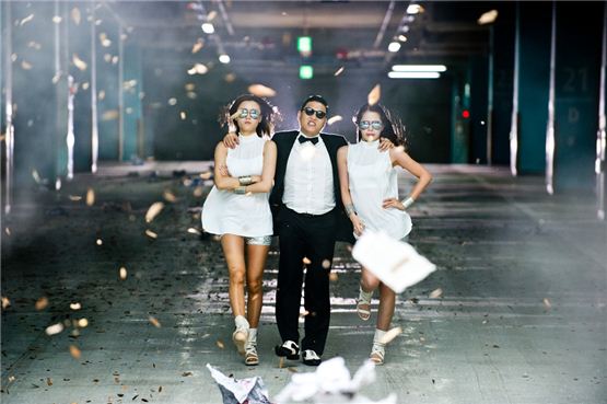 PSY walks out from a parking lot with his female backdancers in the music video for "Gangnam Style," the title song of his sixth studio album "Six rules, Pt. 1" released on July 15, 2012. [YG Entertainment]