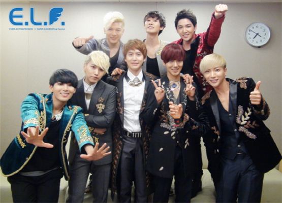Super Junior members Shindong (top left), Eunhyuk (top center), Kangin (top right), Ryeowook (bottom left), Sungmin (bottom second to left), Kyuhyun (bottom center), Yesung (bottom second to right), Lee Teuk (right) celebrate their first win on Mnet' music show "M! CountDown," on July 12, 2012. [SM Entertainment]