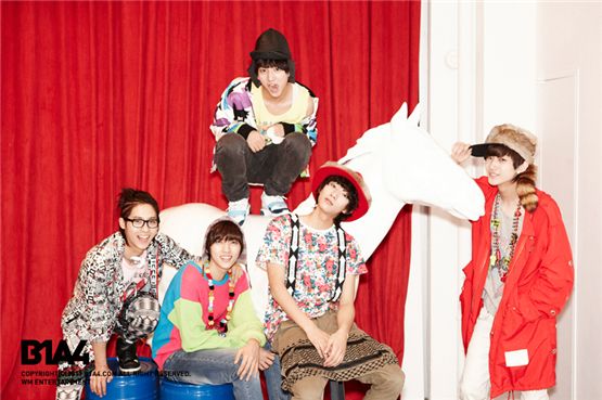 B1A4 members CNU (bottom left), Sandeul (second to left), Baro (top middle), Gongchan (second to right) and Jinyoung (right) posing for a group shot. [WM Entertainment]