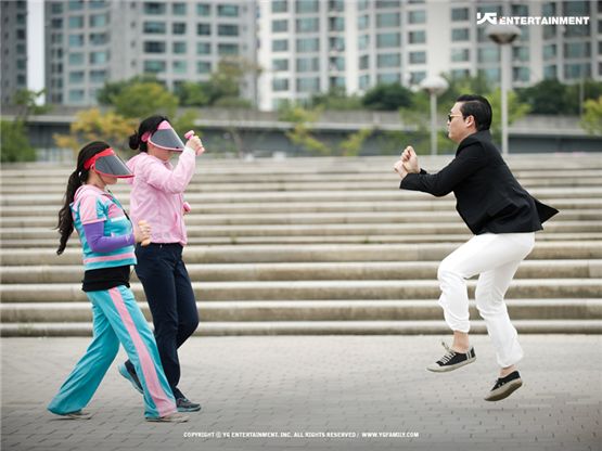 Korean singer PSY (right) is seen boogying down during the shoot for his music video to "Gangnam Style." [YG Entertainment]