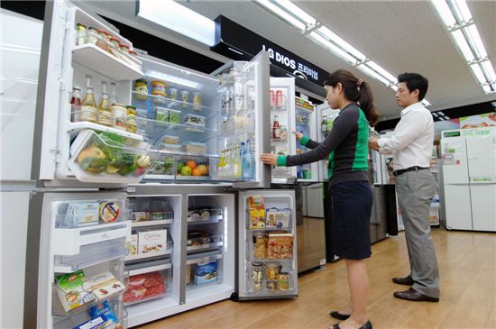 소비자가 LG 베스트샵 매장에서 세계 최대 910리터 냉장고를 구경하는 모습.