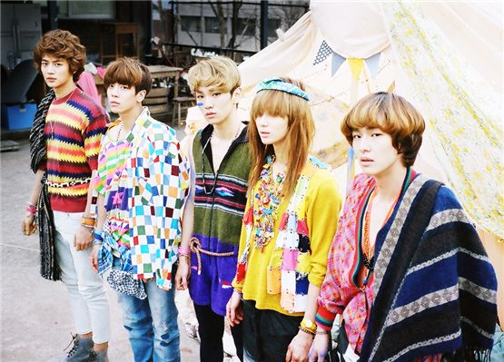SHINee members Minho (left), Jonghyun (second to left), Key (center), Taemin (second to right) and Onew (right) donned in colorful outfits pose for a group shot for their album fourth mini-album "Sherlock" released in March. [SM Entertainment]