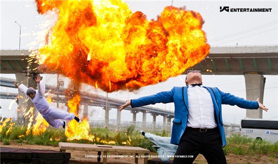 K-pop solo artist PSY spreads out his arms in a blue jacket in the still-shot of "Gangnam Style," dropped on July 15, 2012. [YG Entertainment]