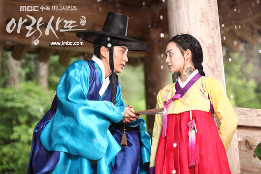 A still shot of actor Lee Joon-gi (left) and actress Shin Min-a (right) staring at each other in MBC "Tale of Arang," which began airing on August 15, 2012. [MBC]