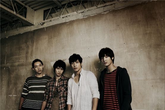 CNBLUE members Lee Jung-shin (left), Lee Jong-hyun (second to left), Jung Yong-hwa (second to right) and Kang Min-hyuk (right) pose together for a group shot for their 1st full-length Japanese album "CODE NAME BLUE," which went on sale in Japan on August 29, 2012. [FNC Entertainment]