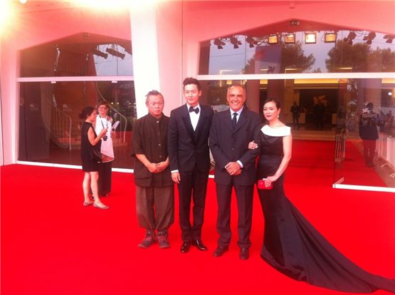 Director Kim Ki-duk (left), actor Lee Jung-jin (second to left) and actress Cho Min-soo (right) pose at the 69th Venice Film Festival's red carpet in Venice, Italy, on September 4.

