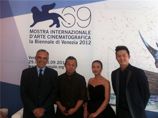 Director Kim Ki-duk (second to left), actress Cho Min-soo (second to right) and actor Lee Jung-jin (right) pose together at the 69th Venice Film Festival opening in Venice, Italy, on September 4.