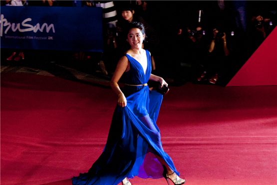 Korean actress Moon Geun-young lightly holds up her long blue dress and walks on black and silver strapped heels during the 17th Busan International Film Festival's red carpet at the Busan Cinema Center in Busan, South Korea, on October 4, 2012. [Lee Jin-hyuk/10Asia]