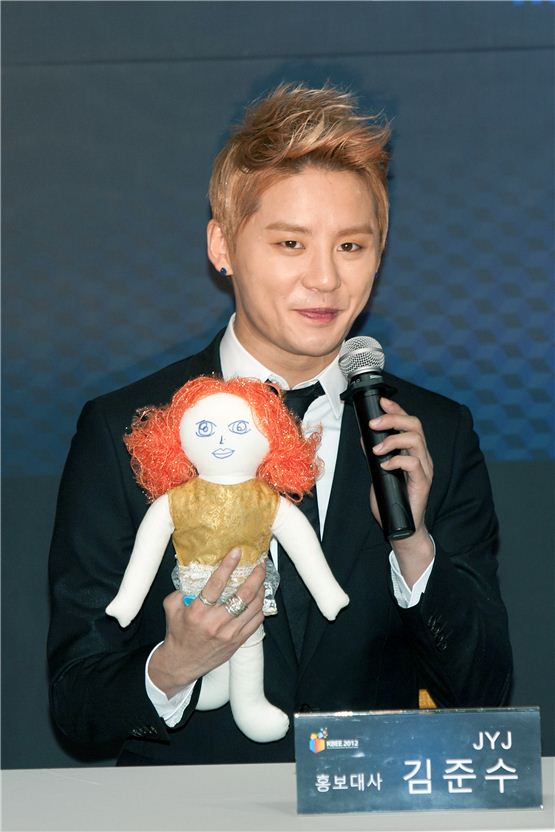 JYJ member Kim Junsu shows his AWOO doll, a part of the UNICEF's campaign to donate its profit, during the appointment ceremony of Korea Brand & Entertainment Expo [KBEE2012], held at Korea Trade-Investment Promotion Agency's head office in southern Seoul, Korea on October 17, 2012. [Lee Jin-hyuk/10Asia]