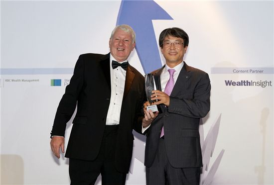 ▲존 에반스(John Evans) PBI지 주편집장(왼쪽)과 이현주 하나은행 부행장(오른쪽)이 24일(현지시간) 싱가포르 플러톤호텔에서 열린 PBI 주최 '글로벌 웰스 어워드 2012'에서 기념촬영을 하고 있다. 