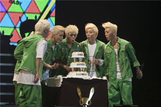 Him Chan (left), Young-jae (second to left), Dae-hyun (center), Jong-up (second to right) and Bang Yong-guk (right) blow cake candles for their first fan club inauguration day titled "1st Baby Day," held at Seoul's Korea University Hwajeong Gymnasium in Korea on October 28, 2012. [Brandon Chae/10Asia] 