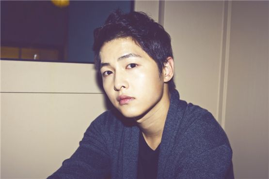 Korean actor Song Joong-ki poses in front of the camera in a photo taken during an interview with 10Asia. [Chae Ki-won/10Asia]