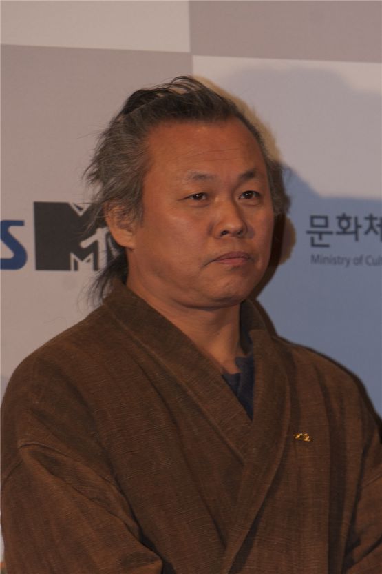 Director Kim Ki-duk poses as he arrives at the 2012 Popular Culture & Art Awards in Seoul, South Korea, on November 19, 2012. [Brandon Chae/10Asia]