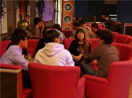 ▲ 싱글 해외여행 참가자들이 테이블에 둘러 앉아 대화를 나누고 있다.