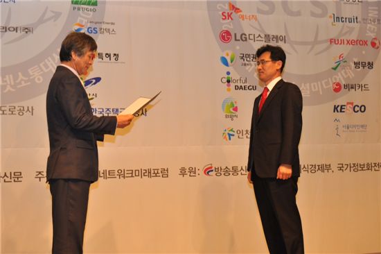 김시형(오른쪽) 특허청 대변인이 이봉 한국인터넷소통협회장으로부터 중앙행정기관 인터넷소통 대상을 받고 있다.