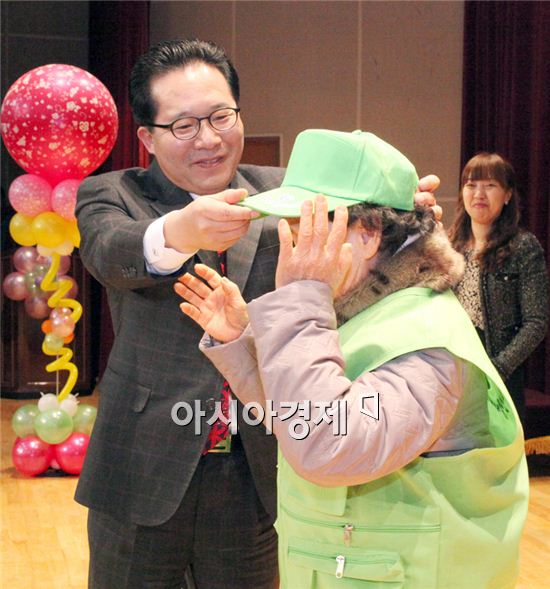 노희용 동구청장이 노인 일자리 창출 발대식에서 어르신에게 모자를 쓰워 주고 있다.