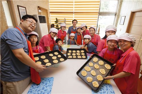 지난 27일 녹십자 임직원과 배우자, 자녀들이 가족봉사캠프에 참가해 아동 복지시설과 나눔가게에 전달할 빵과 쿠키를 만들고 있다. <사진제공=녹십자>