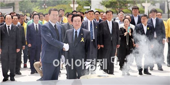 강운태 단일후보와 이용섭 후보가 27일 오전 5.18국립묘지를 찾아 공동헌화 분향한 뒤, 악수를 나누고 있다. 