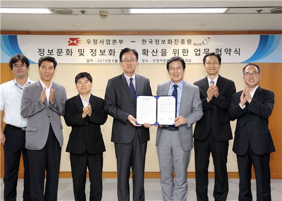 우정사업본부와 한국정보화진흥원의 정보문화 및 정보화 진흥 확산을 위한 업무협약식이 24일 우정사업본부에서 열려 김준호 우정사업본부장(왼쪽)과 장광수 한국정보화진흥원장이 협약서를 들고 환하게 웃고 있다. 이번 협약으로 매년 우체국 중고 PC 1만대가 '사랑의 그린PC'사업을 통해 국내외 소외계층에 전달된다. 