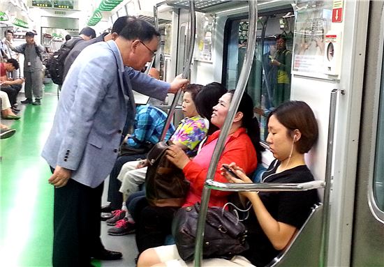 정홍원 총리가 지하철에서 한 시민과 대화를 나누고 있다.