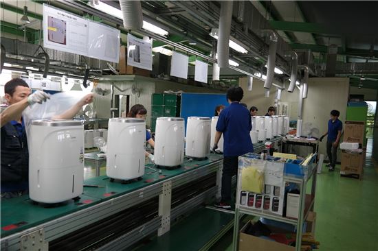 위닉스 시흥공장 제습기 생산라인 관계자들이 제품 조립 마무리 작업을 하고 있다.