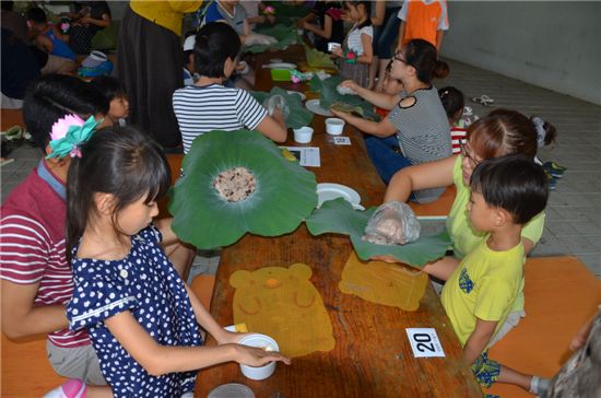 '연잎밥 만들기체험'을 하고 있는 축제참가자 가족들