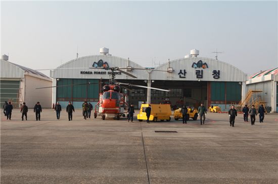 서울산림항공관리소 직원들이 서울 강서구 공항로 계류장에서 양옆으로 늘어서서 산림헬기 운항에 문제되는 게 없는지 현장점검을 하고 있다.  

