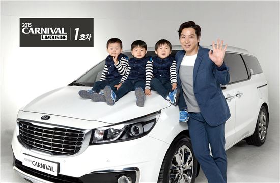 기아차가 '2015 카니발 7인승 리무진' 모델 1호차의 주인공으로 배우 송일국 씨를 선정해 차량 전달식을 가졌다. 송일국 씨가 삼둥이(대한·민국·만세)와 함께 기념 촬영을 하고 있는 모습
