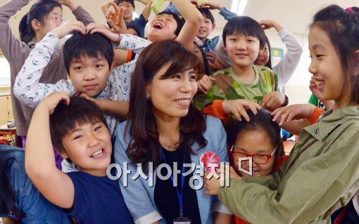 지난해 스승의 날(5월15일) 서울 강서구 등촌동 등마초등학교에서 학생들이 담임선생님에게 카네이션을 달아드리며 사랑의 하트를 보이고 있다.