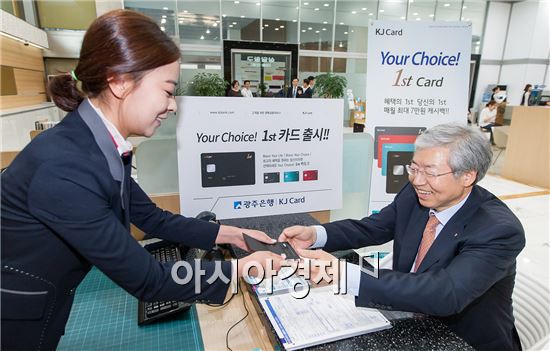 JB금융그룹 김한 회장이 광주은행과 전북은행이 공동 기획한 1st카드 첫 번째 신규가입을 하고 카드를 전달 받고 있다.