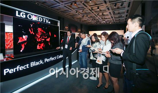 ▲아시아 지역 'LG 이노페스트'에 참가한 아시아 지역 가전 딜러들이 'LG 시그니처' 올레드 TV를 살펴보고 있다.(제공=LG전자)