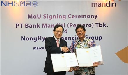 NH농협금융 김용환 회장(사진 왼쪽)과 만디리은행 부디 사디킨 은행장이 상호협력 및 발전을 위한 MOU를  체결하고 있다.
