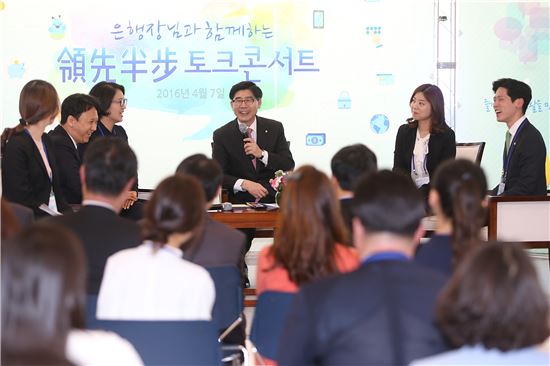 지난 7일 이광구 은행장(사진 가운데)이 서울 중구 본점에서 열린 토크콘서트에서 우수직원 40여명과 함께 영업현장 직원들의 의견을 청취하고 있다.(출처: 우리은행) 
