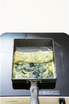 4. 팬에 식용유를 두르고 달걀물을 부어 익히다가 돌돌 만다.