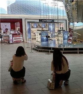 ▲지난 22일 신세계면세점 10층에 있는 '회전목마' 작품 앞에서 중국인관광객들이 기념사진을 찍고 있다.