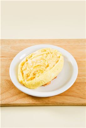 4. 준비한 볶음밥을 그릇에 담고 달걀을 올려 반으로 잘라 밥이 덮이도록 한다.
