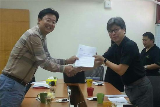 김범기 라디안 대표(왼쪽)가 대만 더마케어바이오메드 관계자와 수출계약서를 들어보이고 있다.<사진=라디안>