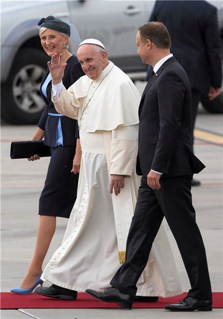 ▲26일(현지시간) 폴란드 크라쿠프 공항에 도착한 프란치스코 교황이 안제이 두다 폴란드 대통령 내외의 환영을 받으며 손을 흔들고 있다. 