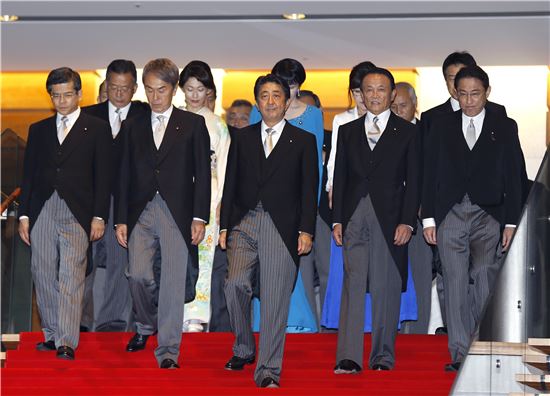 ▲3일 신규 내각 인사들을 이끌고 계단을 걸어내려오는 아베 신조 일본 총리(가운데). (AP = 연합뉴스)